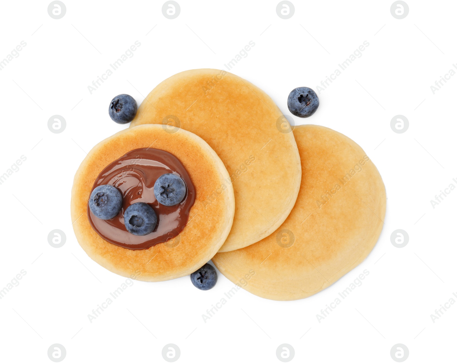 Photo of Tasty pancakes with chocolate spread and blueberries isolated on white, top view