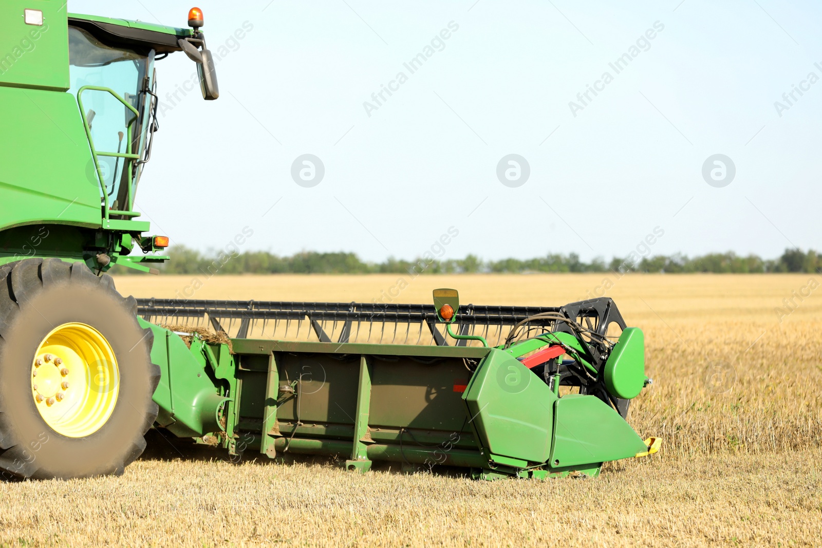 Photo of Modern combine harvester working in agricultural field