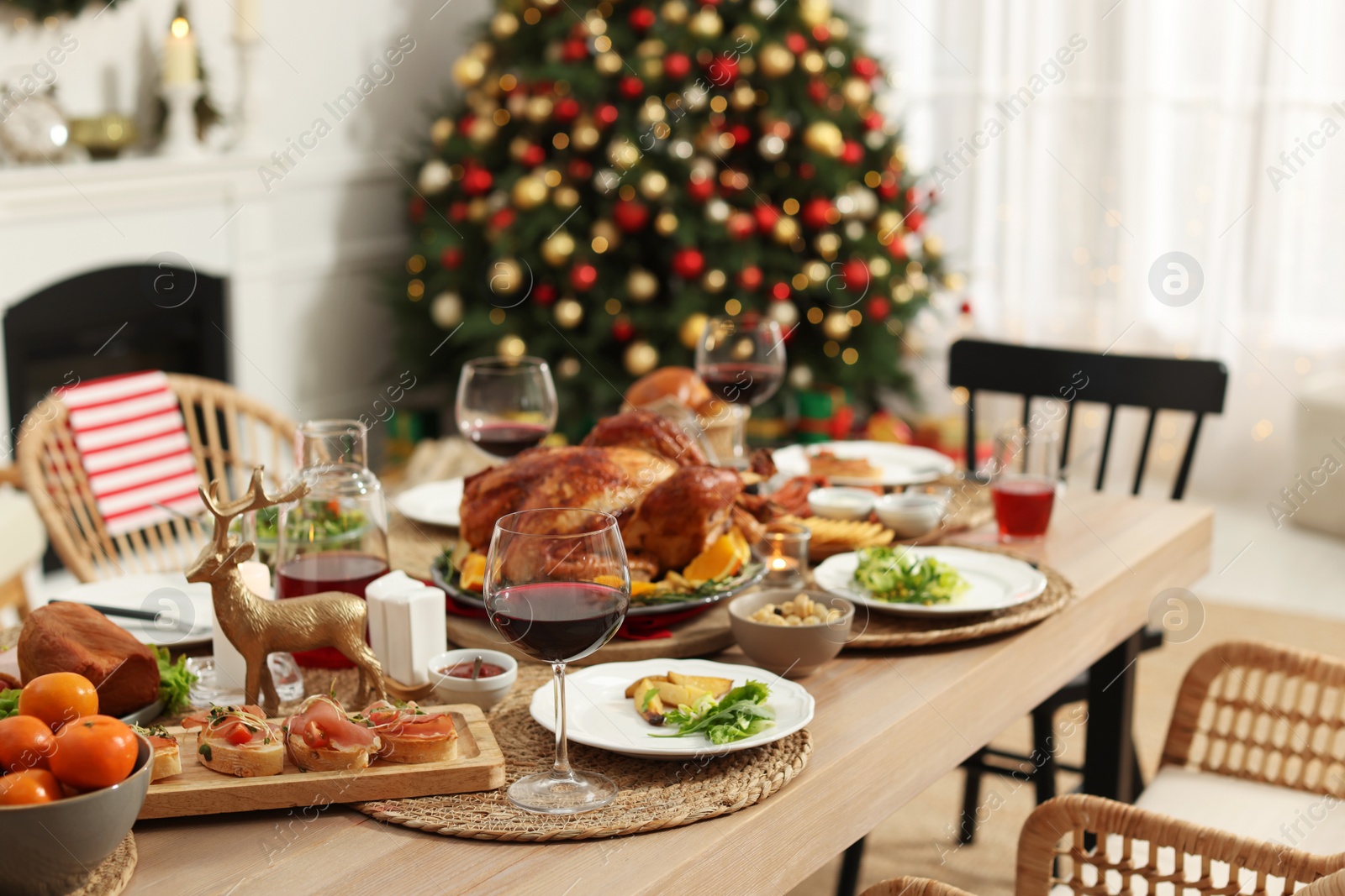 Photo of Festive dinner with delicious food and wine on table indoors. Christmas celebration