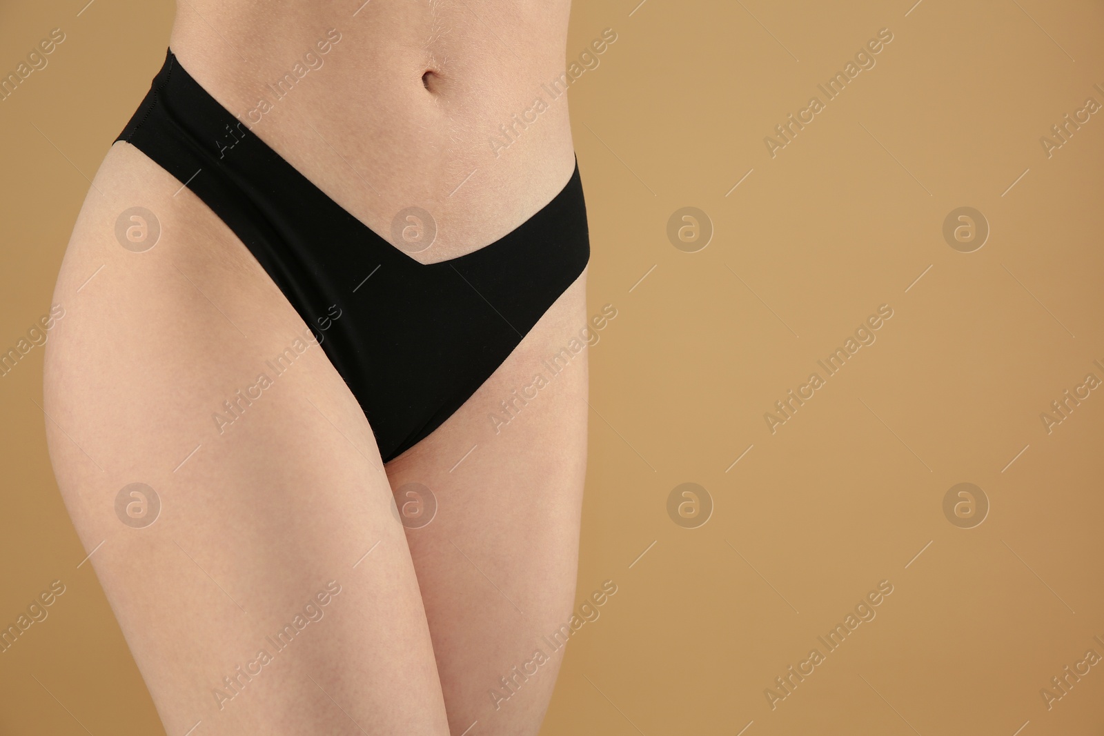 Photo of Gynecology. Woman in underwear on beige background, closeup. Space for text