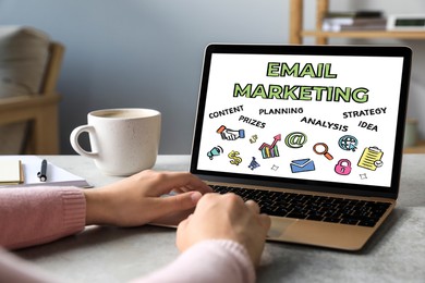 Image of Email marketing. Woman using laptop at table, closeup