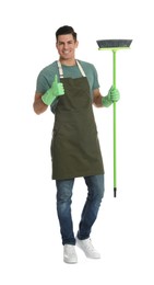 Photo of Man with green broom on white background