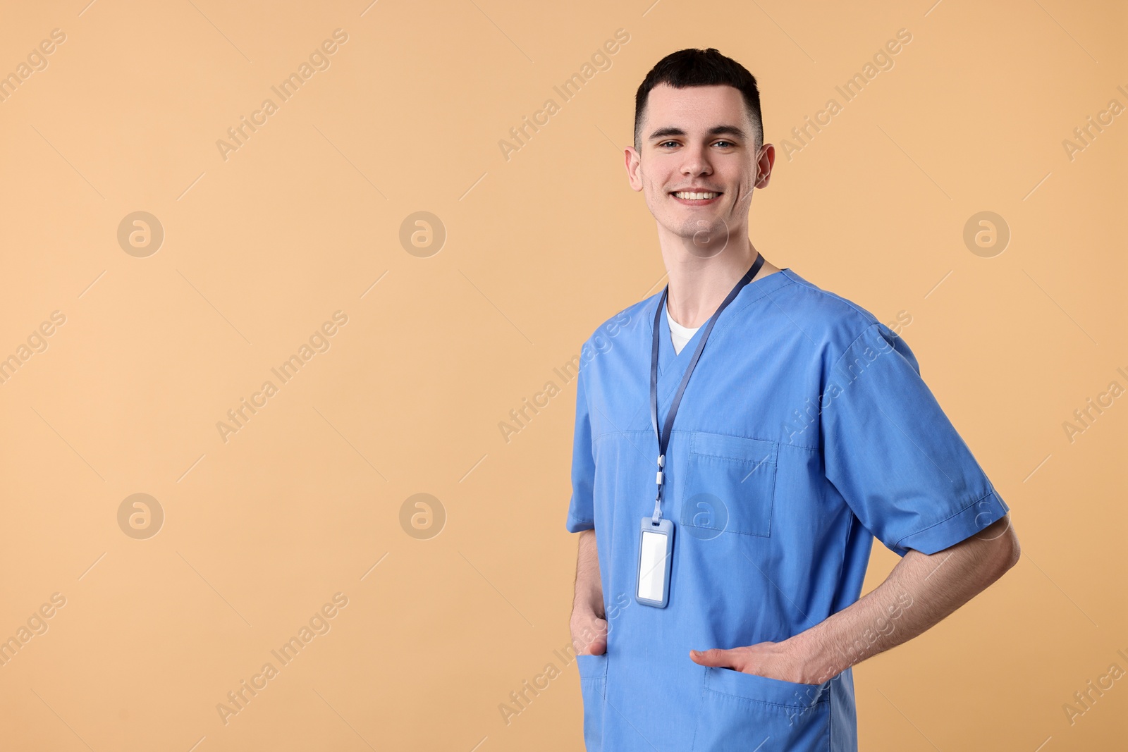 Photo of Portrait of smiling medical assistant on beige background. Space for text