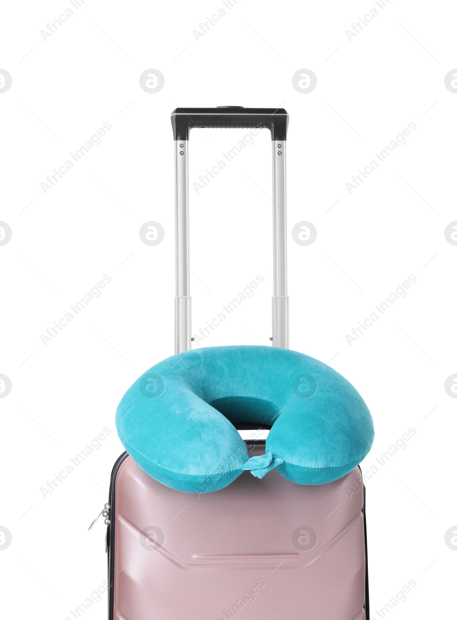 Photo of Light blue travel pillow on suitcase against white background