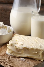 Photo of Tasty homemade butter and dairy products on wooden table, closeup