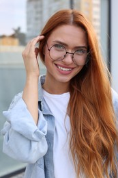 Portrait of beautiful woman in glasses outdoors