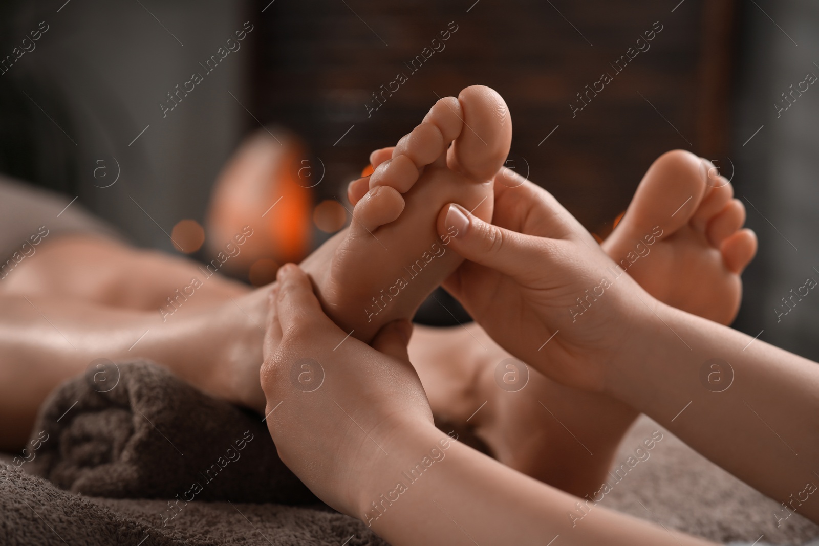 Photo of Woman receiving foot massage in spa salon, closeup