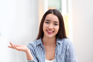 Photo of Beautiful woman using video chat for conversation indoors