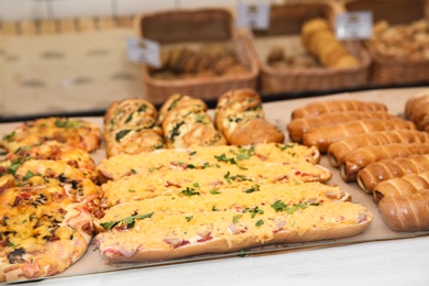 Photo of Fresh pastries on counter in bakery store