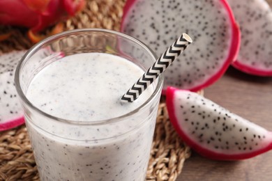 Delicious pitahaya smoothie and fresh fruits on table, closeup