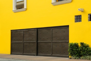 Photo of Closed metal gates of modern garage. Exterior design
