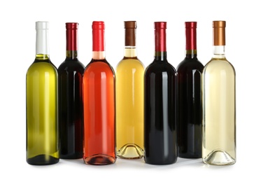 Photo of Bottles with different wine on white background