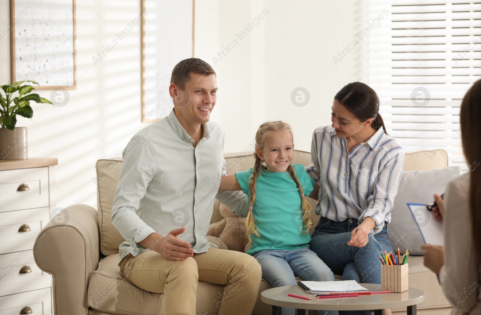 Photo of Family on appointment with child psychotherapist indoors