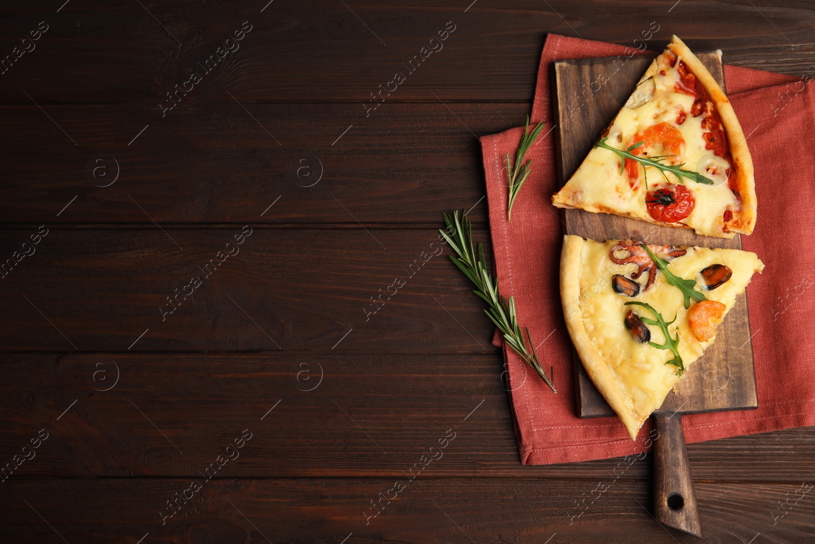 Photo of Pieces of delicious seafood pizza on wooden table, flat lay. Space for text