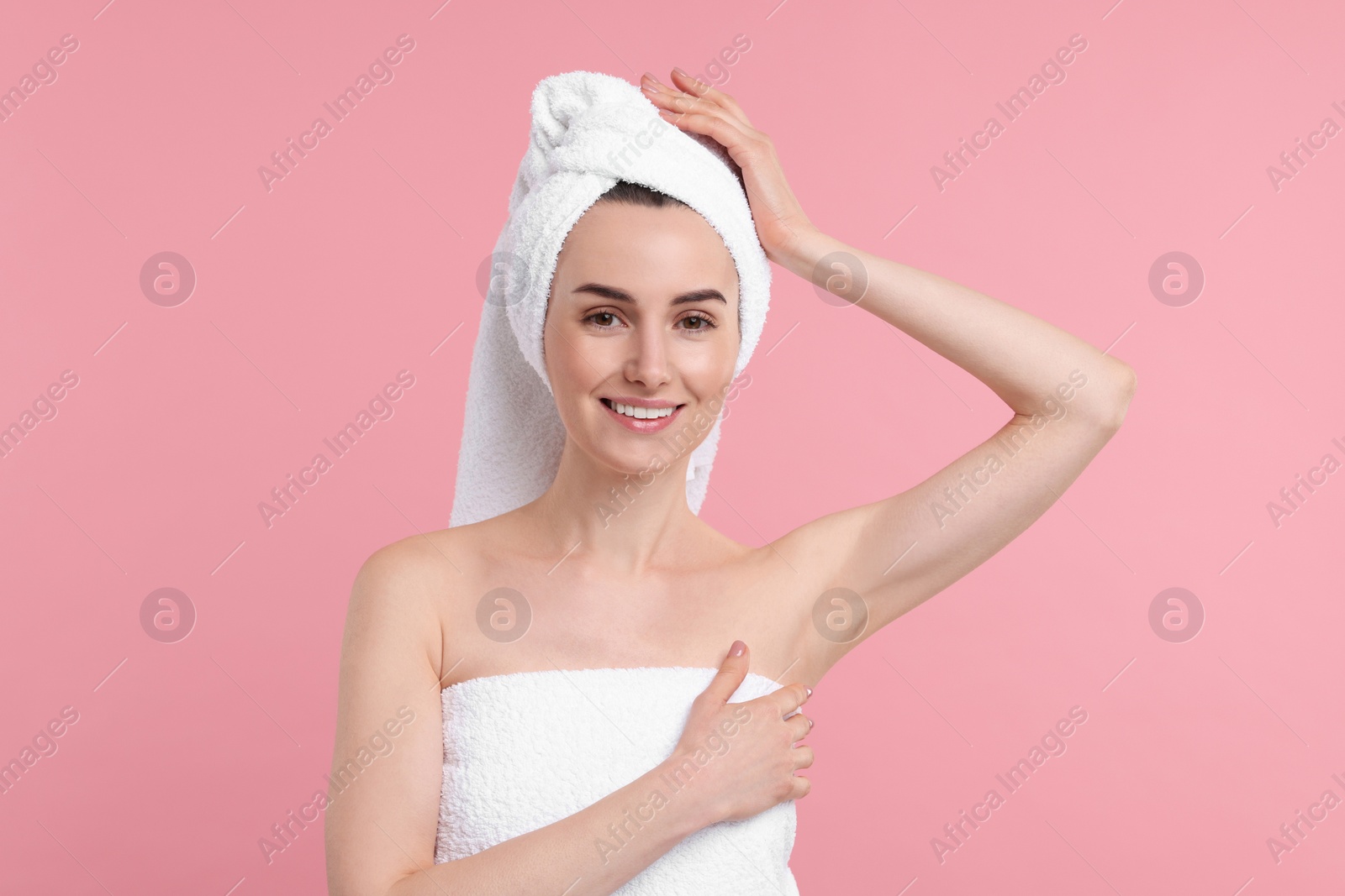 Photo of Beautiful woman showing armpit with smooth clean skin on pink background