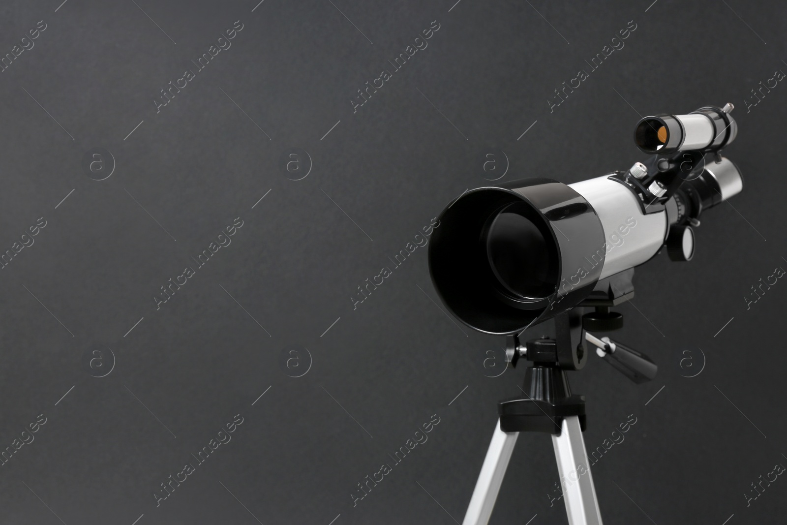 Photo of Tripod with modern telescope on black background, closeup. Space for text