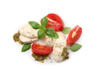 Tasty salad Caprese with mozzarella, tomatoes, basil and pesto sauce isolated on white, top view