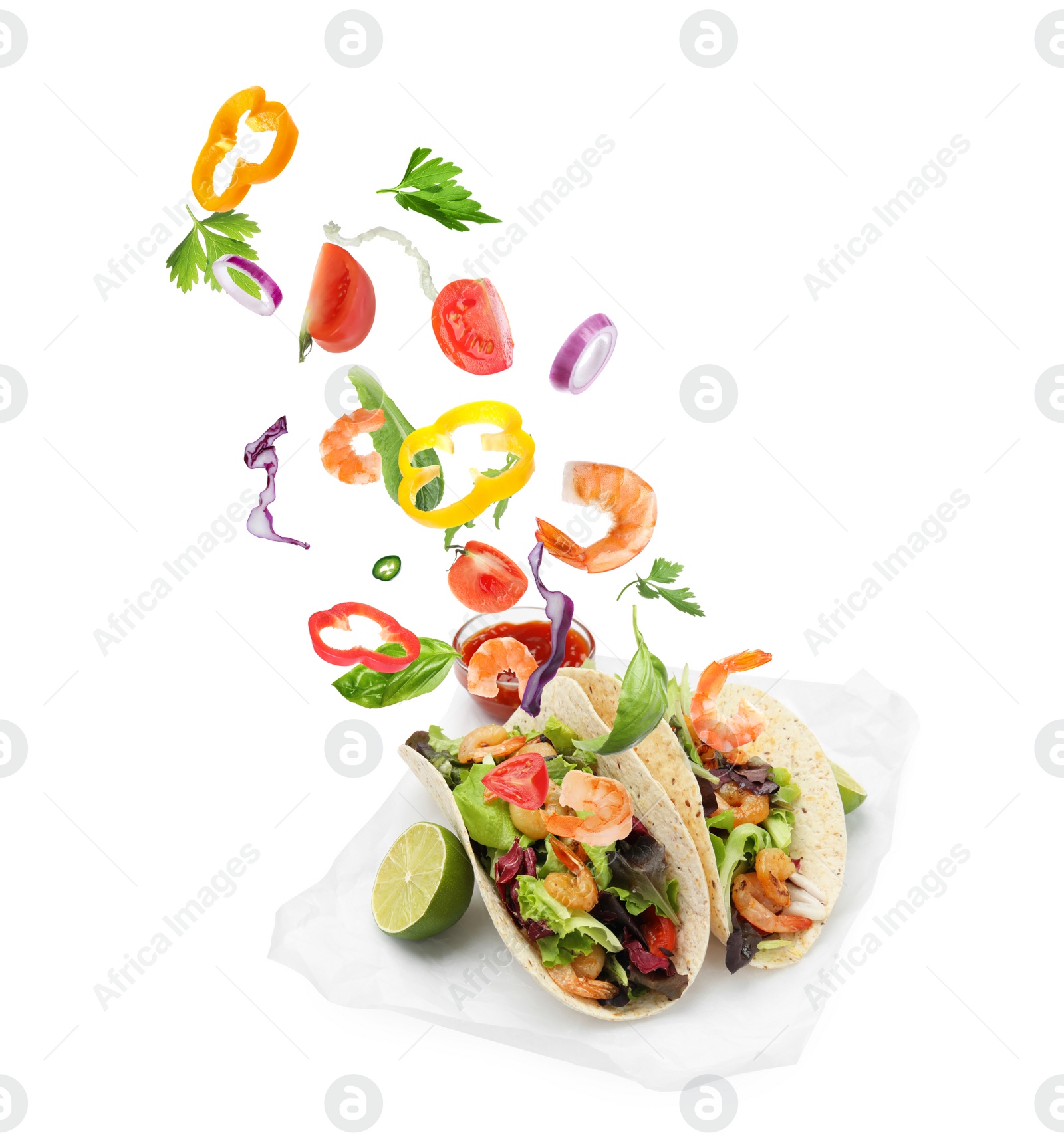 Image of Delicious tacos. Ingredients falling into tortillas on white background