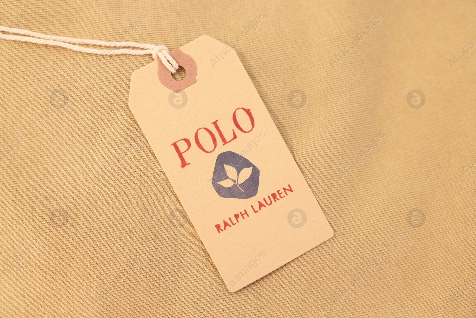 Photo of Leiden, Netherlands - December 6, 2023: Polo Ralph Lauren clothing tag on beige garment, top view