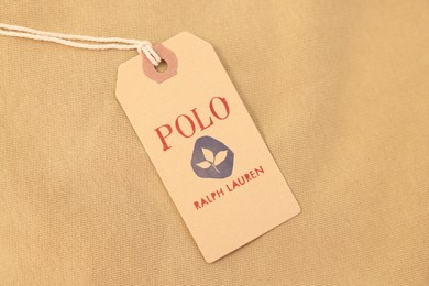 Leiden, Netherlands - December 6, 2023: Polo Ralph Lauren clothing tag on beige garment, top view