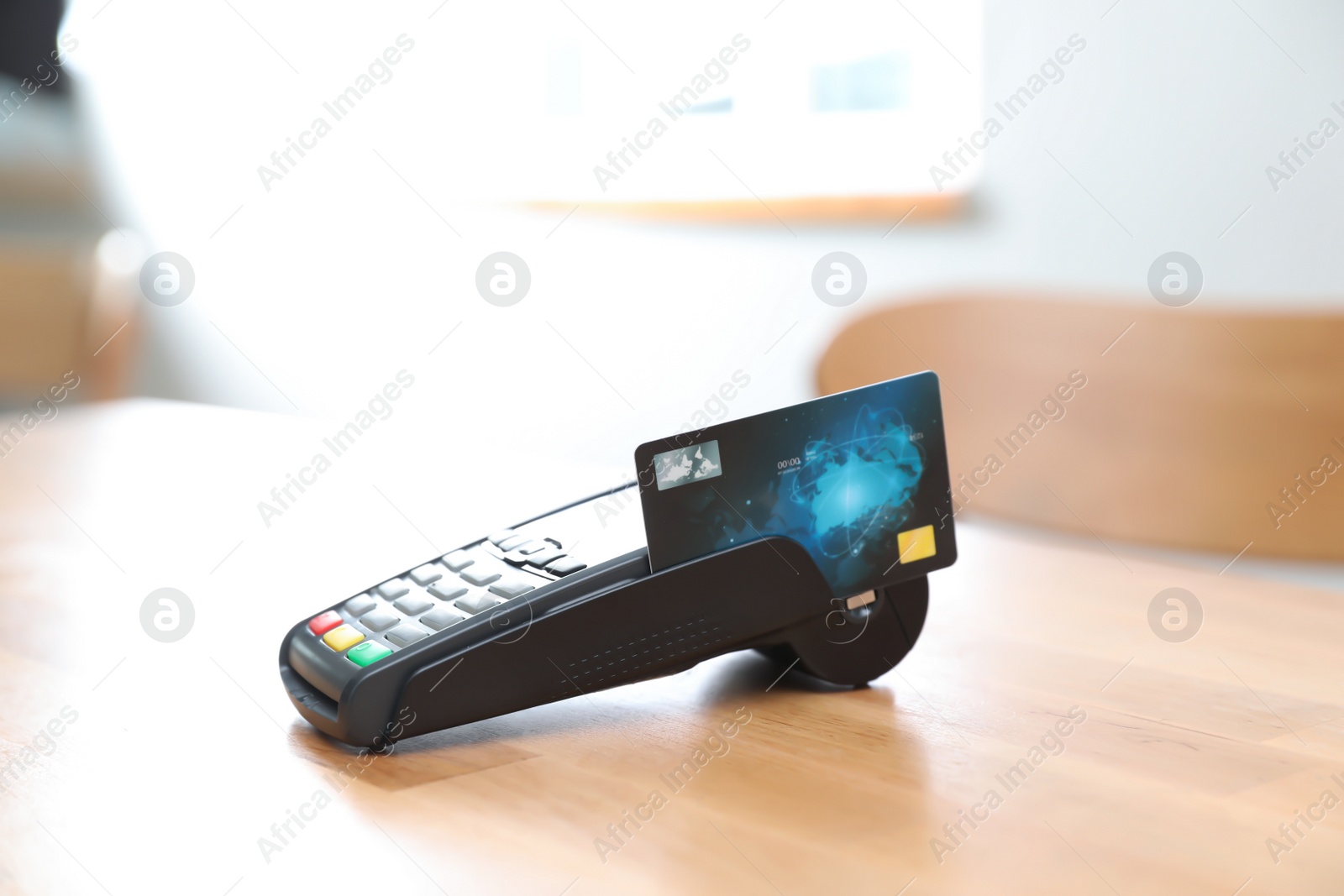 Photo of Credit card machine for non cash payment on wooden table indoors