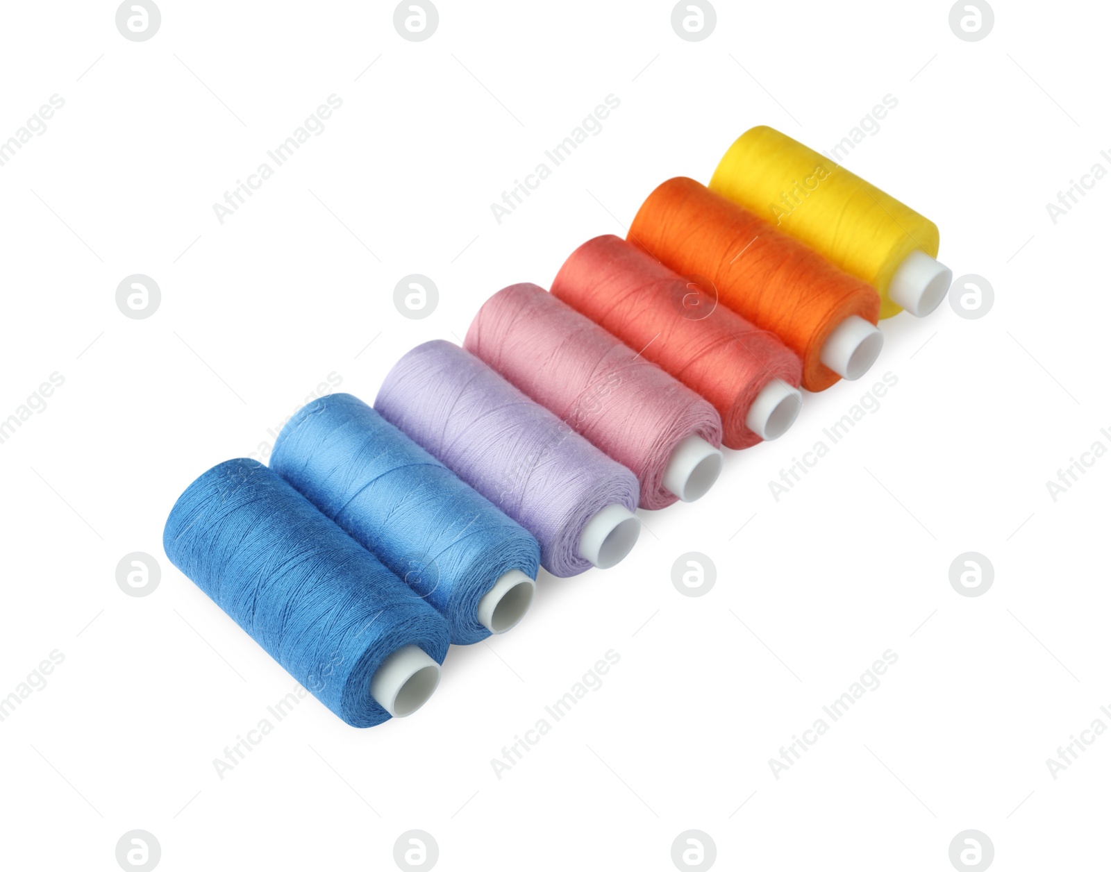 Photo of Set of different colorful sewing threads on white background