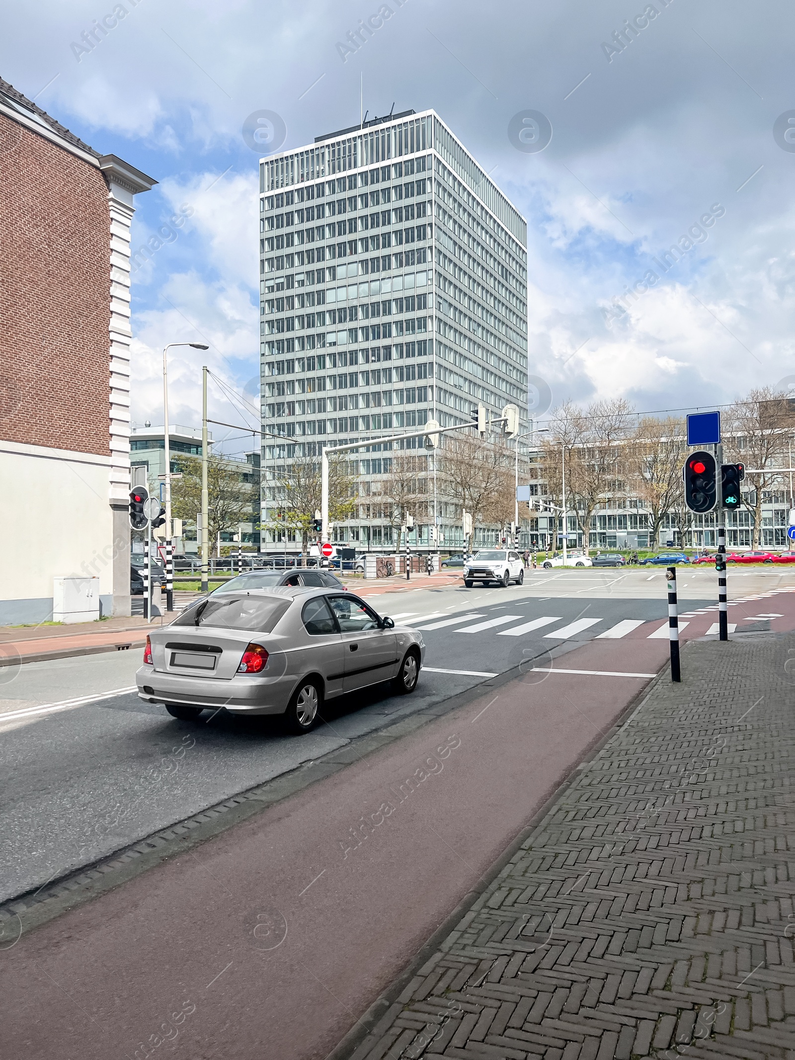 Photo of Beautiful buildings and modern cars on city street