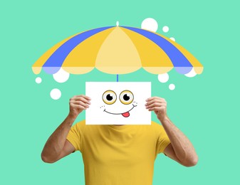 Image of Man with paper smiling face and summer umbrella hat on bright turquoise background. Party concept. Stylish creative design