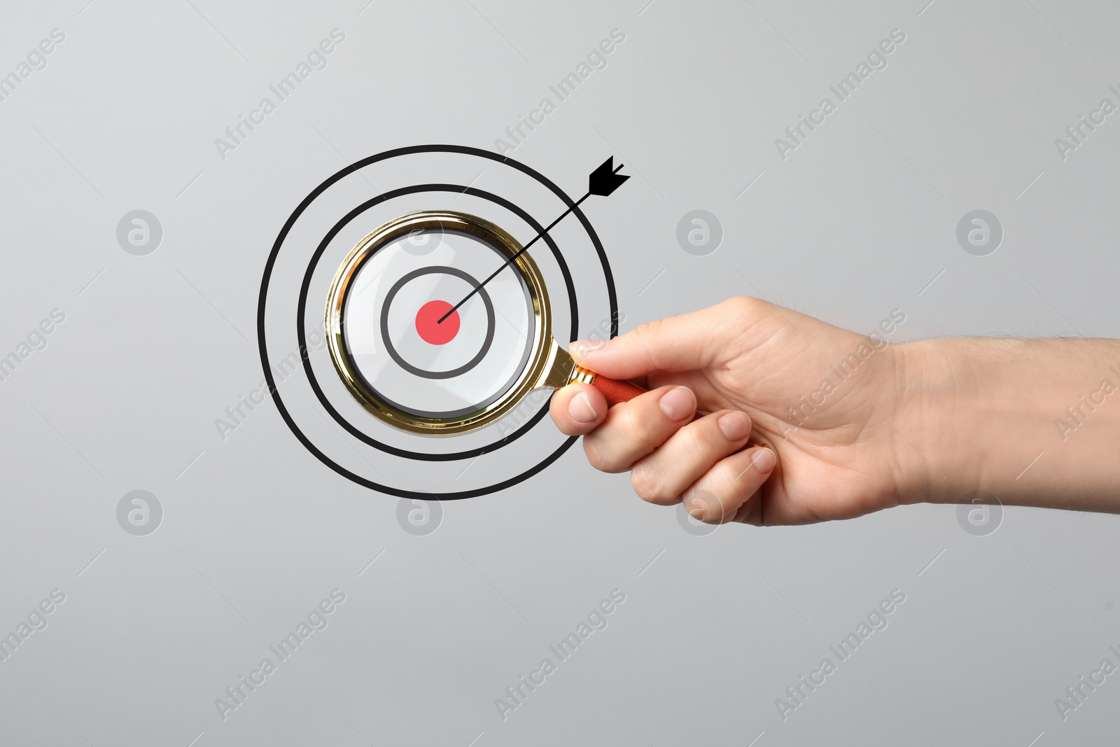 Image of Woman holding magnifying glass on light grey background, closeup. Illustration of target and arrow