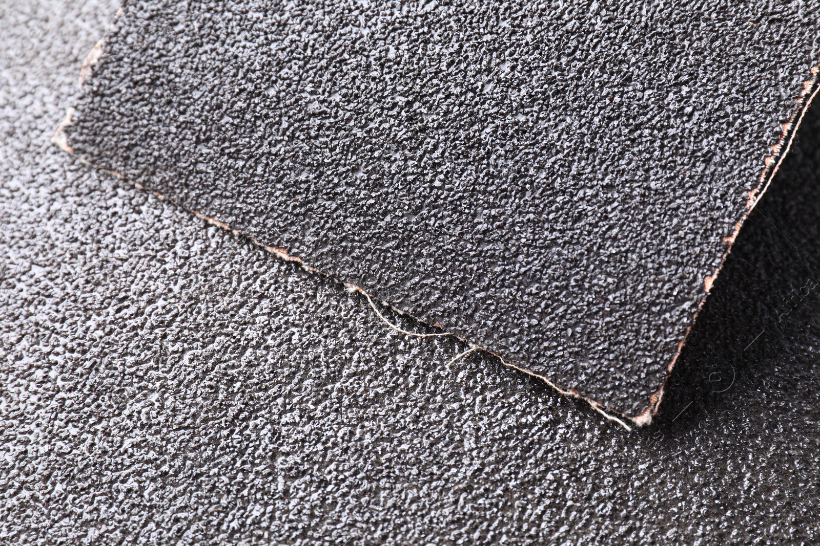 Photo of Sheets of coarse sandpaper as background, top view