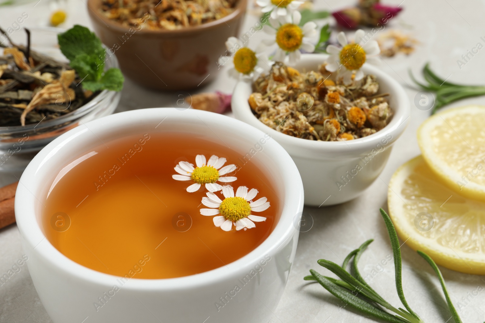 Photo of Cup of fresh aromatic chamomile tea, closeup