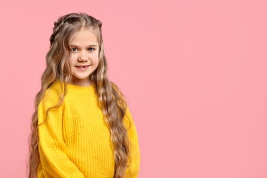 Cute little girl with braided hair on pink background. Space for text