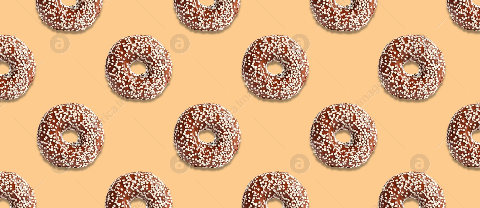 Image of Creative pattern design of glazed donuts on pale orange background, banner