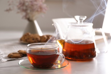 Glass cup of hot tea served for breakfast on white table