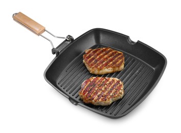 Grill pan with delicious pork steaks isolated on white