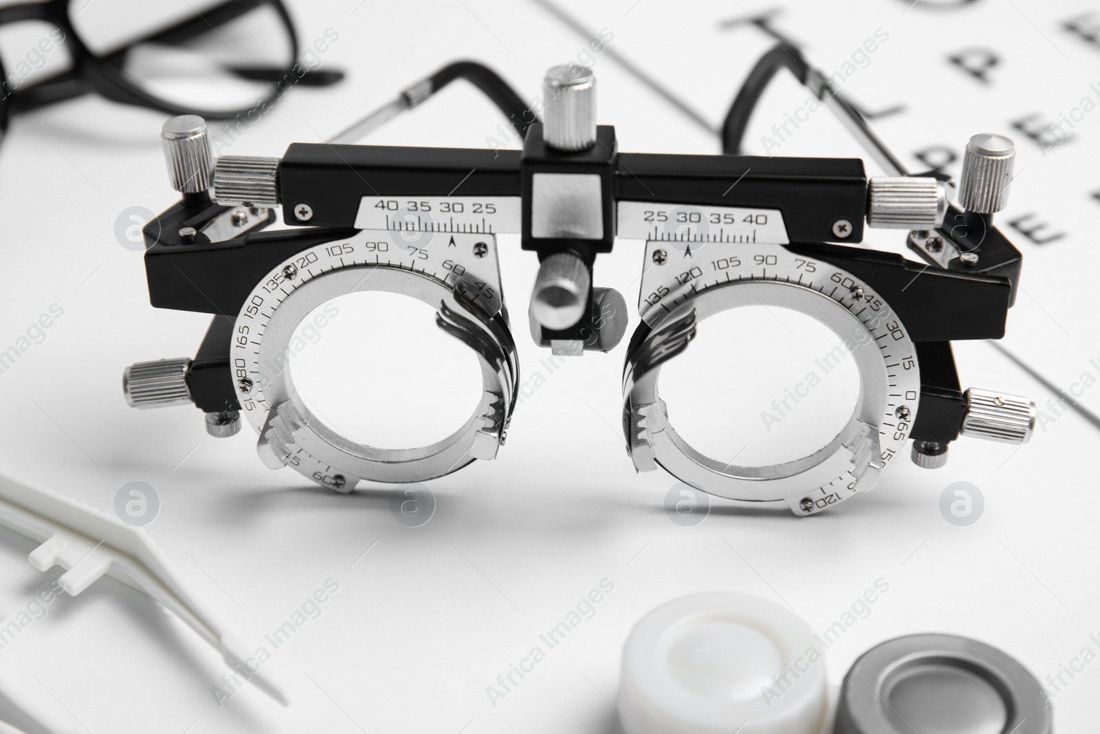 Photo of Trial frame on white background, closeup. Ophthalmologist tool