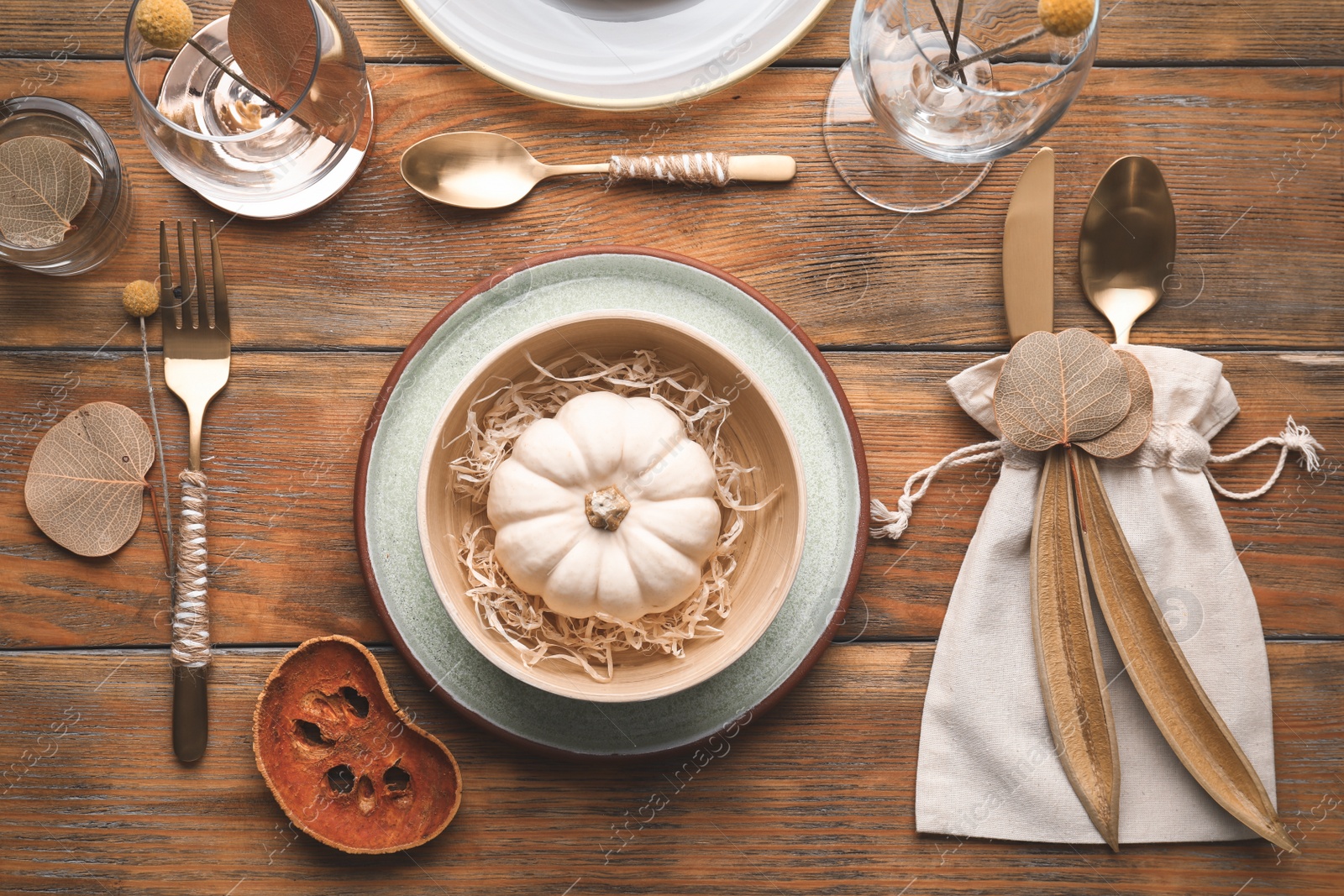 Photo of Autumn table setting with pumpkin and decor on wooden background, flat lay