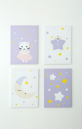 Photo of Different cute pictures on white wall. Children's room interior elements
