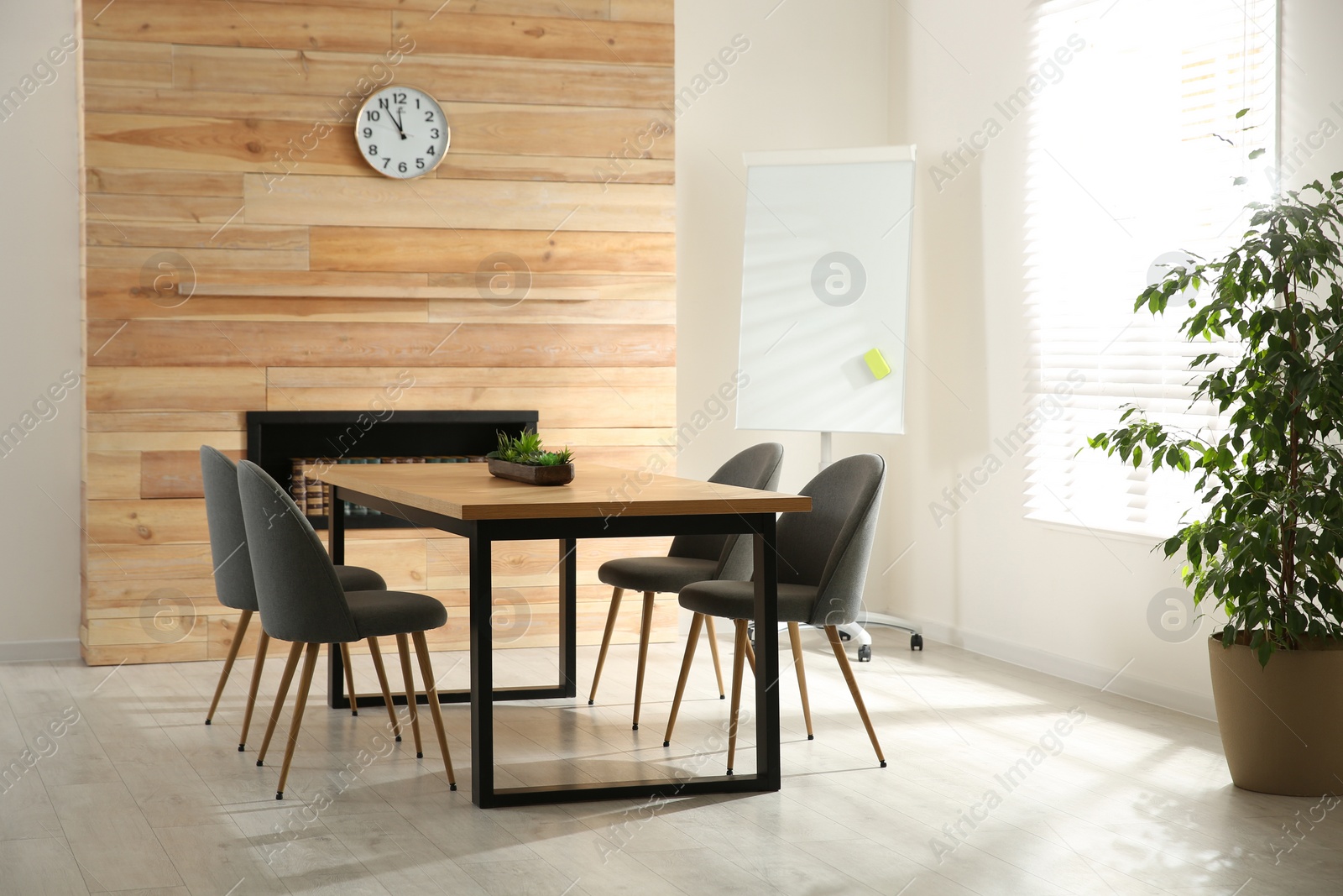 Photo of Modern meeting room interior with large table and chairs