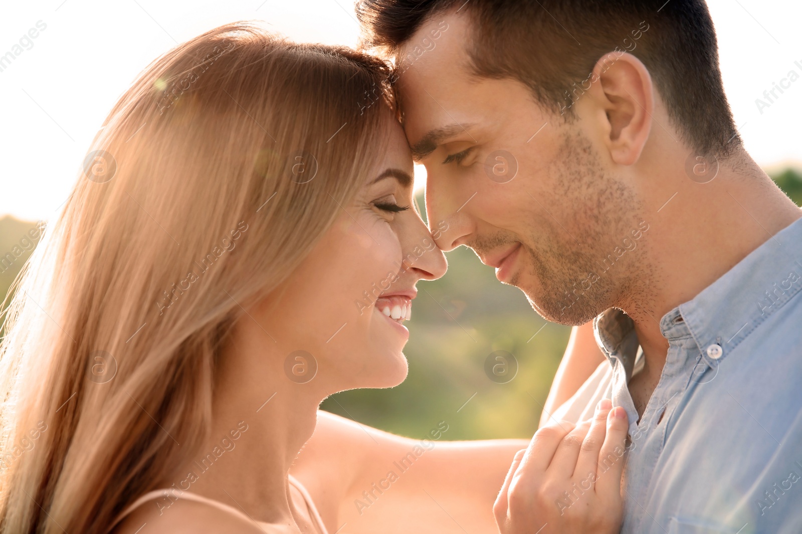 Photo of Cute young couple in love posing outdoors on sunny day