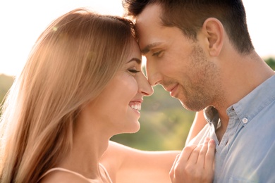 Photo of Cute young couple in love posing outdoors on sunny day