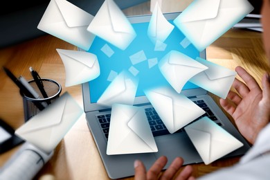 Image of Email spam. Man with laptop and many letters, closeup