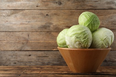 Photo of Ripe white cabbage on wooden table. Space for text