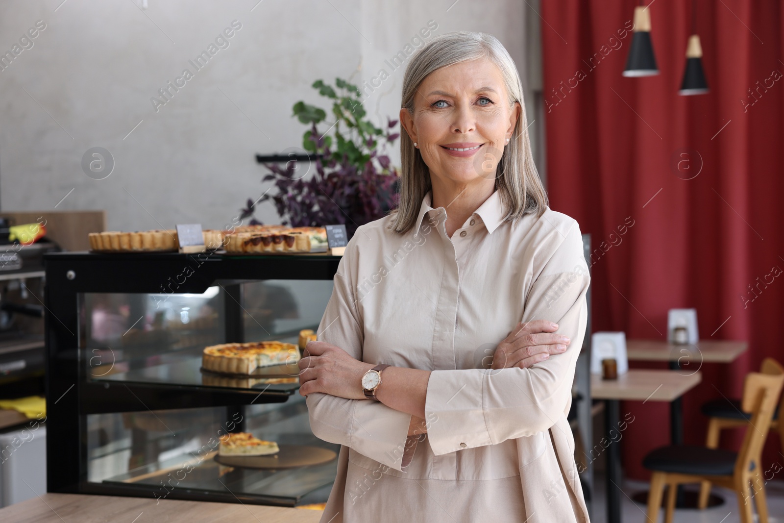 Photo of Portrait of happy business owner in her cafe