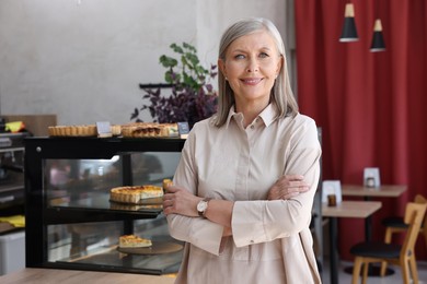 Photo of Portrait of happy business owner in her cafe