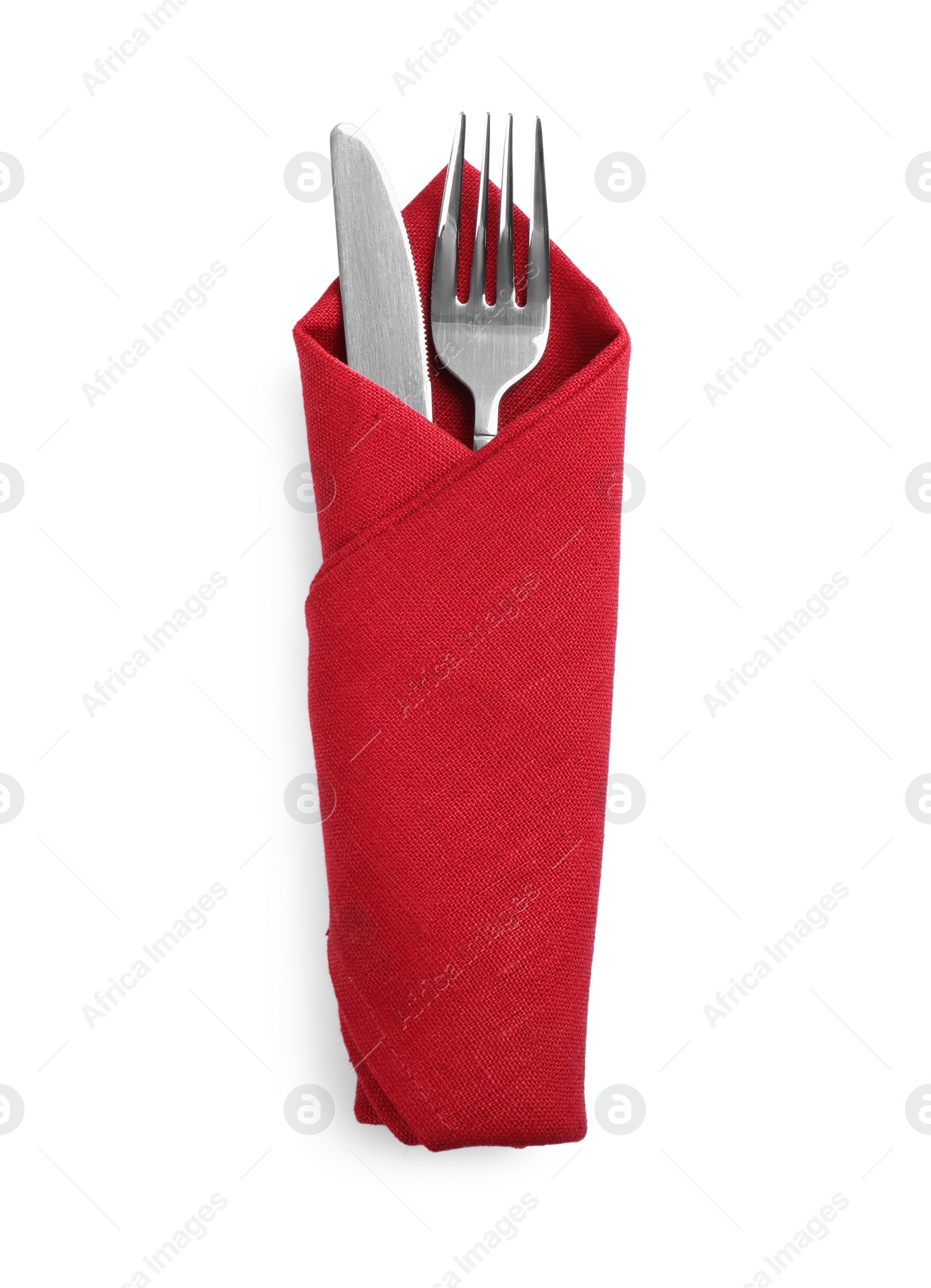 Photo of Fork and knife wrapped in red napkin on white background, top view