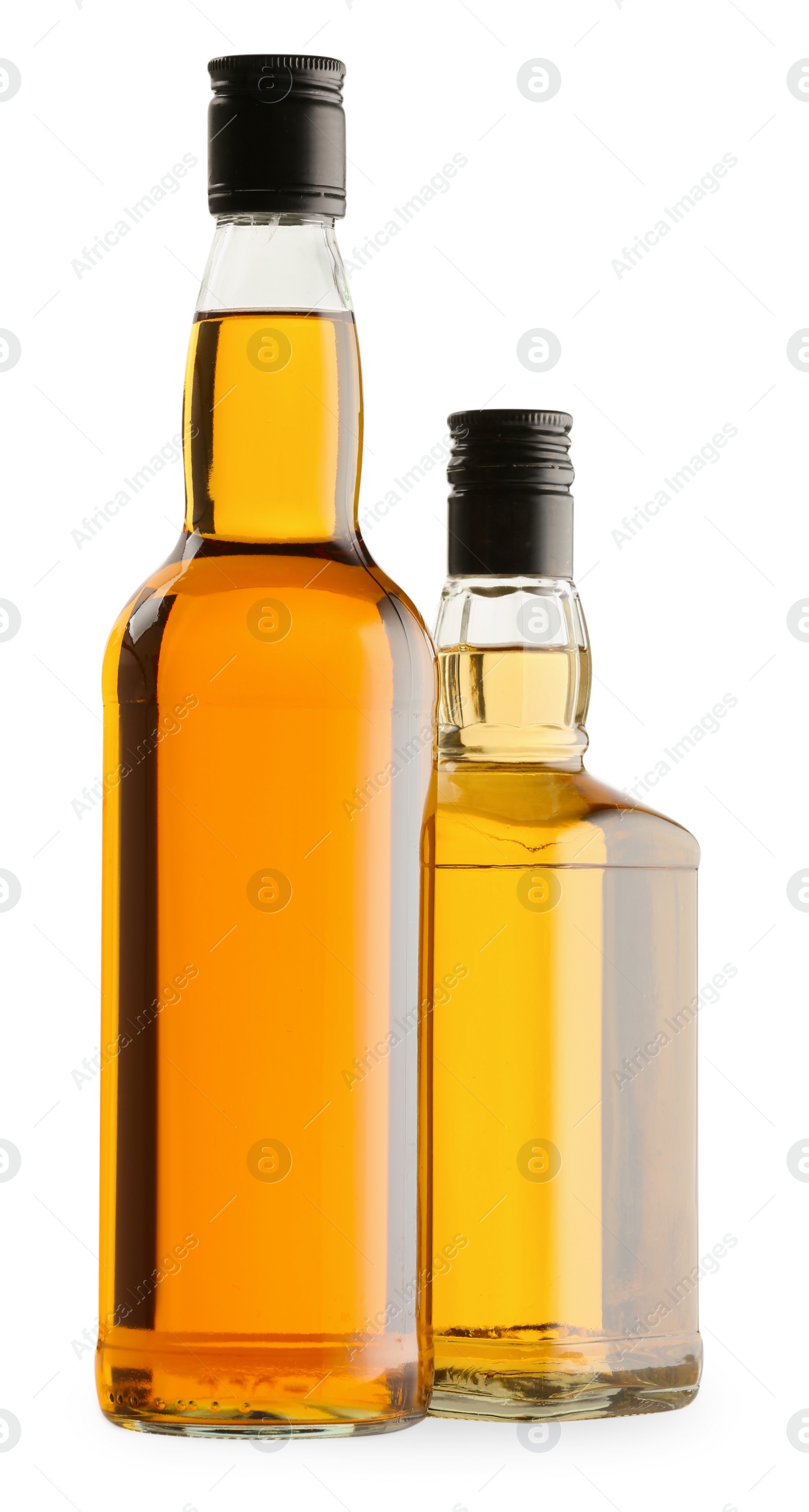 Photo of Different sorts of whiskey in glass bottles isolated on white