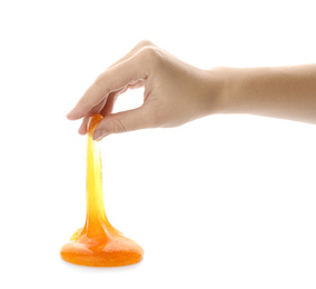 Photo of Woman playing with orange slime isolated on white, closeup. Antistress toy