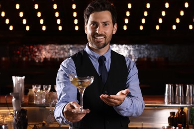 Photo of Bartender with fresh alcoholic cocktail in bar