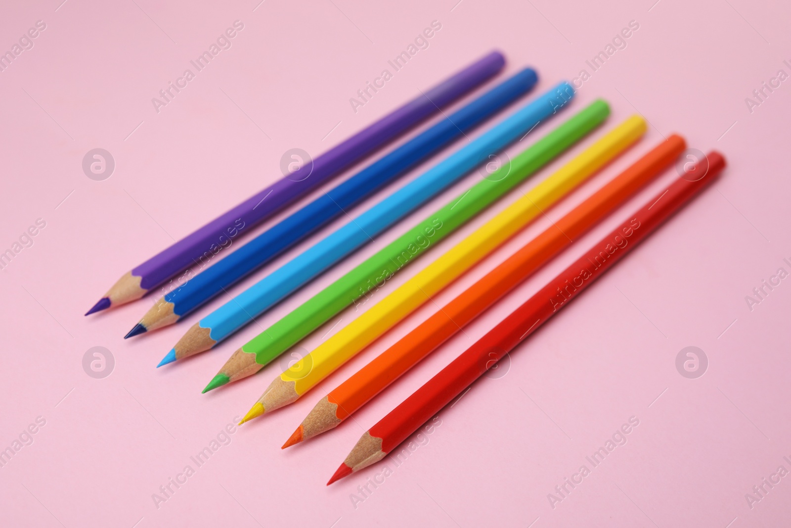 Photo of Many colorful wooden pencils on pink background